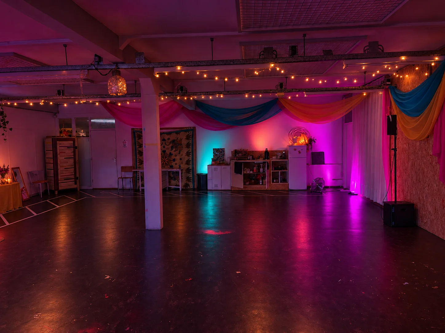 Atmosphere inspiration for Common Ground: colourful fabric and soft pink and turquoise party lighting
